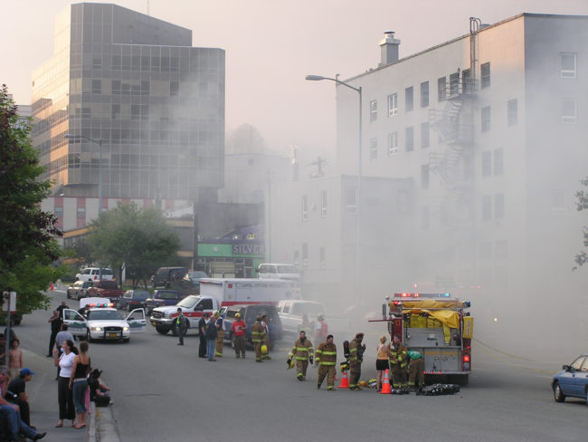 Smoke fills the streets of downtown Juneau as the historic Skinner Building burns, Aug. 15, 2004.  (Creative Commons photo by Gillfoto)
