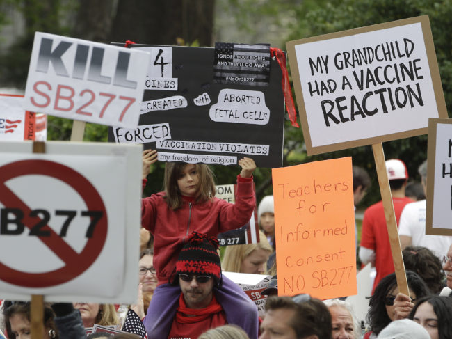 A photo from April shows protesters in Sacramento, Calif., rallying against a bill that would require all school-age children to be vaccinated. The state Senate just passed the measure. Rich Pedroncelli/AP