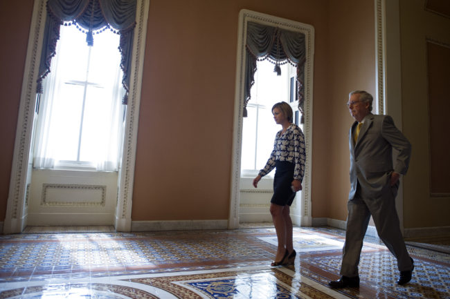 Senate Majority Leader Mitch McConnell, R-Ky., walks from the Senate Chamber after opening a special session to extend surveillance programs in Washington, on Sunday. Cliff Owen/AP