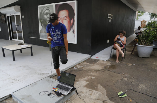 People in Havana use a free Wi-Fi network at a center run by artist Kcho on March 11. It's a small but unprecedented loosening of Cuba's strict Internet regulations by the government. Still, the vast majority of Cubans do not have Internet access. Desmond Boylan/AP