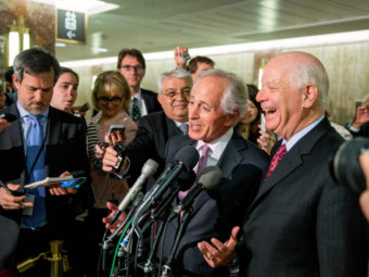 Senate Foreign Relations Committee Chairman Sen. Bob Corker, R-Tenn., center, and the committee's ranking member Sen. Ben Cardin, D-Md., right, were all smiles April 14 after the committee passed an agreement on oversight of Iran negotiations. But the bill has run into some outspoken opponents in the full Senate. (Photo by Andrew Harnik/AP)