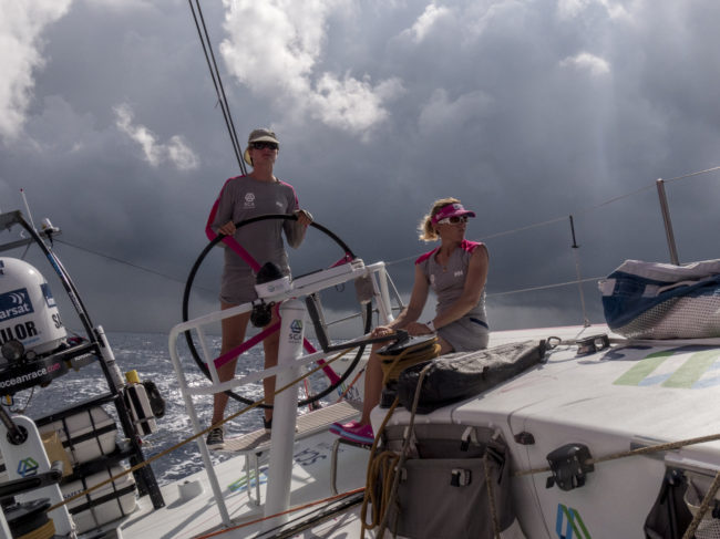 Leg 2 onboard Team SCA, in November 2014. Elodie Mettraux helms and Sam Davies trims main as a squal passes behind the boat. (Photo by Corinna Halloran/Team SCA/Volvo)
