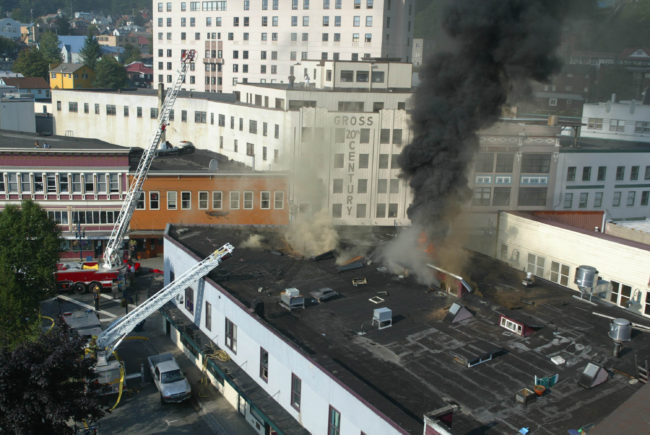 Firefighters tried to cut a hole into the roof of 2004 Skinner Building fire to relieve let the heat and smoke buildup, but they encountered multiple layers of roofs that had been added over the years. (Photo by Brian Wallace) (Photo by Brian Wallace)