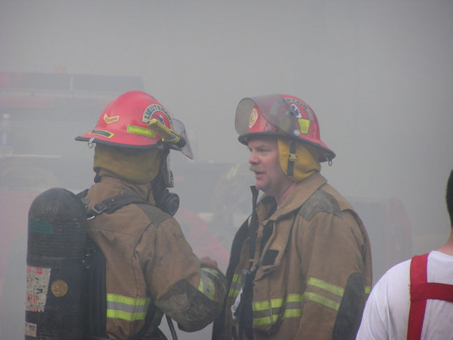 Smoke cuts visibility in downtown Juneau as the historic Skinner Building burns, Aug. 15, 2004.  (Creative Commons photo by Gillfoto)