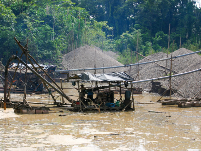 In the Madre de Dios region of eastern Peru, miners use hoses to blast away the soil in the rain forest and then sift the sediment for gold. Jason Beaubien/NPR