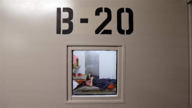 An inmate lies on a bunk reading in the psychiatric unit of the Pierce County Jail in Tacoma, Washington. An estimated 2 million adults with serious mental illnesses are jailed each year. (AP)