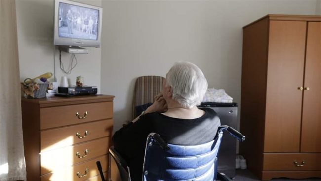 An elderly woman who was abused by a relative watches television inside her room at a retirement community in Mason, Ohio. Inconsistent reporting and scarce resources have hampered efforts to combat the growing problem of elder abuse. (AP)