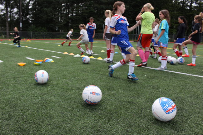 Coach Paris runs the girls through drills. (Photo by Elizabeth Jenkins/KTOO) 