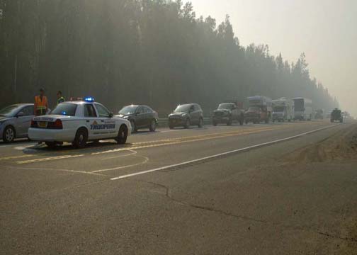 Troopers stop traffic on the Parks Highway Monday morning as part of traffic control along the Parks Highway. (Photo by John Norris - Alaska Public Media)