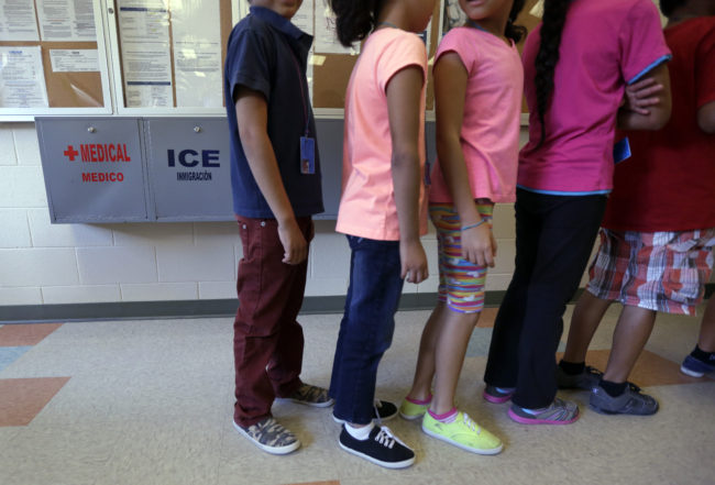 Detained immigrant children line up in the cafeteria at the Karnes County Residential Center, a temporary home for immigrant women and children detained at the border.