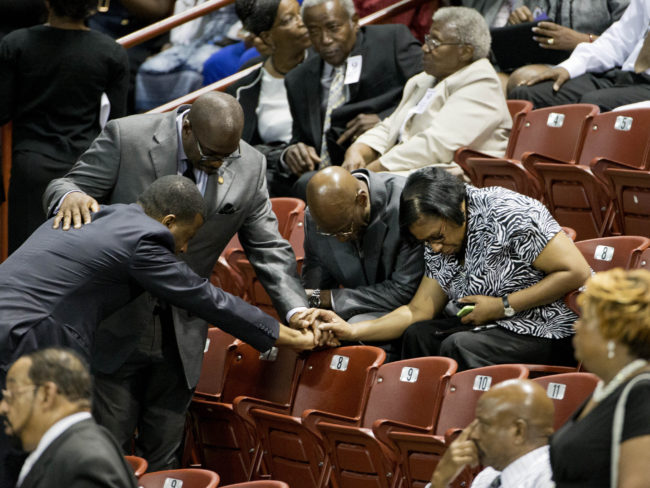 Mourners pray before the funeral service for the Rev. Clementa Pinckney in Charleston, S.C. David Goldman/AP