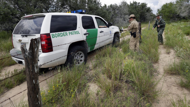 U.S. agents compare notes as they patrol along the Mexico border near McAllen, Texas. A draft report by outside experts calls for steps to confront any claims of corruption in the Border Patrol. Eric Gay/AP