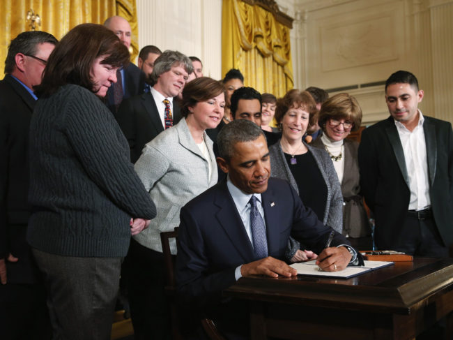 President Obama signs a presidential memorandum in March of 2014 that directed the Department of Labor construct a new set of overtime rules, with the goal of making more employees eligible for overtime pay. Mark Wilson/Getty Images