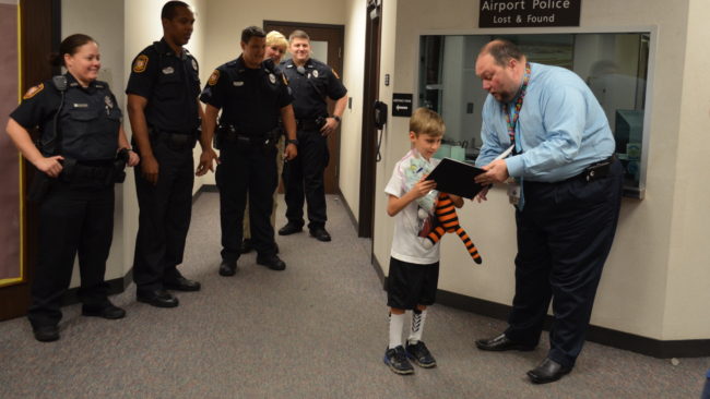 Owen, 6, is reunited with his tiger, Hobbes. He had left the stuffed animal at the airport. (Photo courtesy Tampa International Airport)