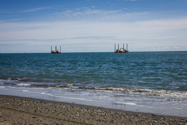 Two dredges mine off the coast of Nome’s West Beach in June 2015. (Photo by Francesca Fenzi)