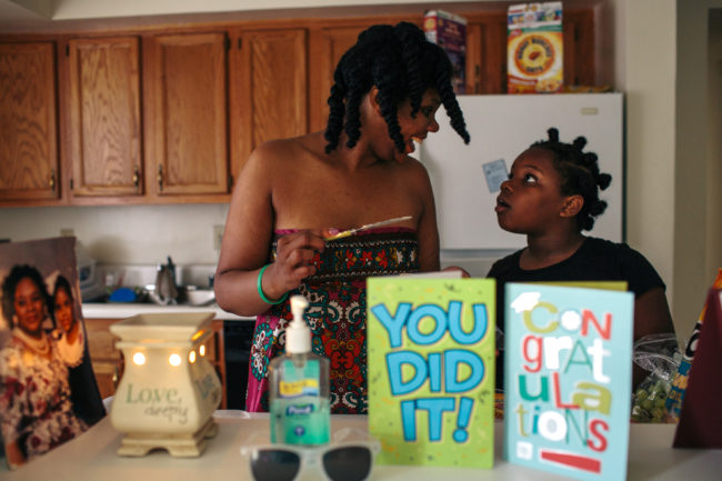 Jordan McClellan gets help making lunch from daughter Kyra Brooks in their apartment in Southeast Washington, D.C. McClellan has been fighting homelessness for most of her adult life, living in family shelters and transitional housing until she was moved into the rapid rehousing program. Lexey Swall/GRAIN for NPR