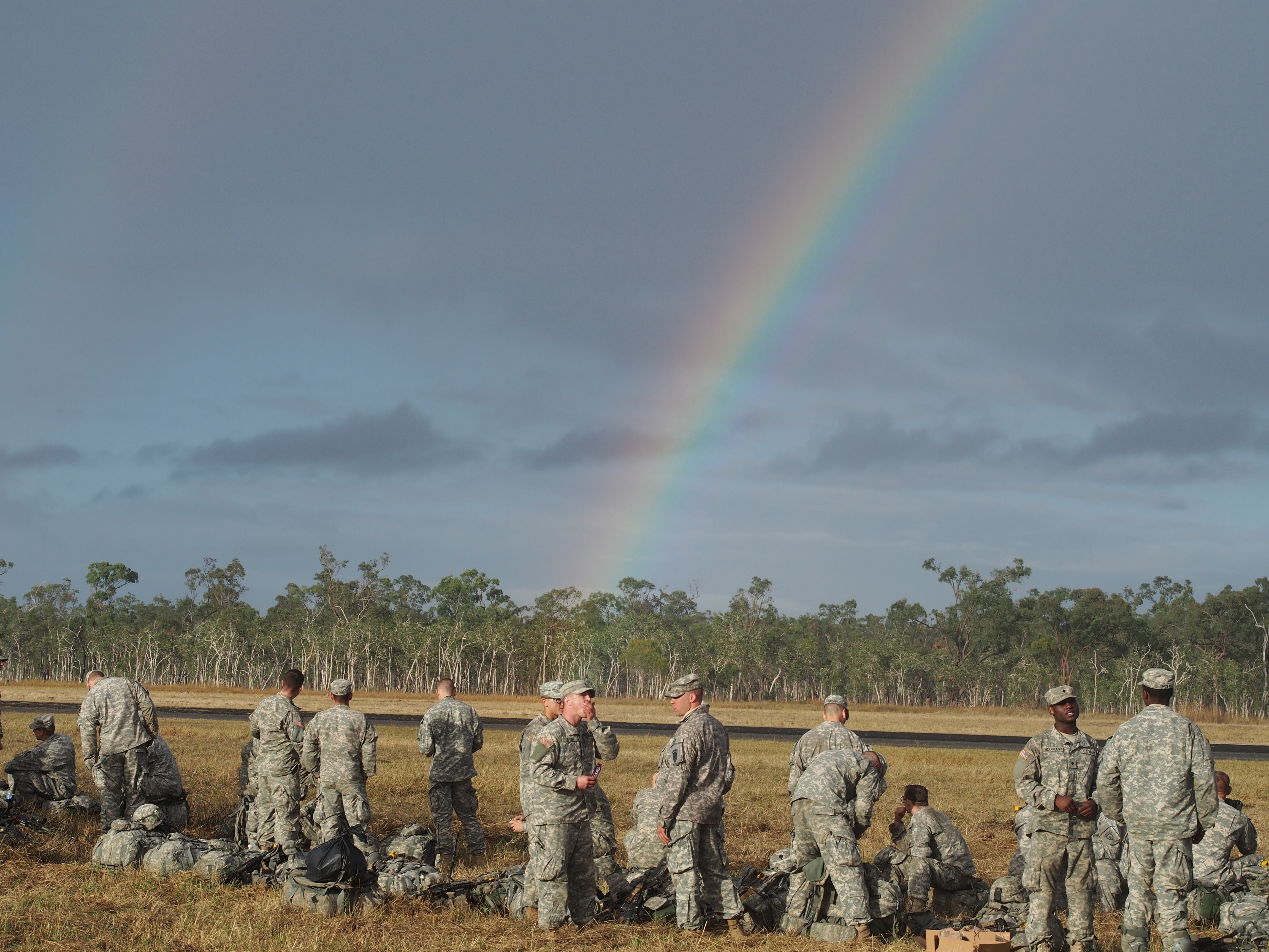 Members of the 4-25th Airborne Brigade congregate under a rainbow during exercise Talisman Saber. (Photo by Zachariah Hughes/KSKA)
