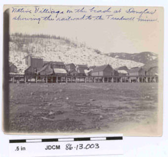 This photo shows the Douglas Indian Village and railroad to the Treadwell mines in 1900.
