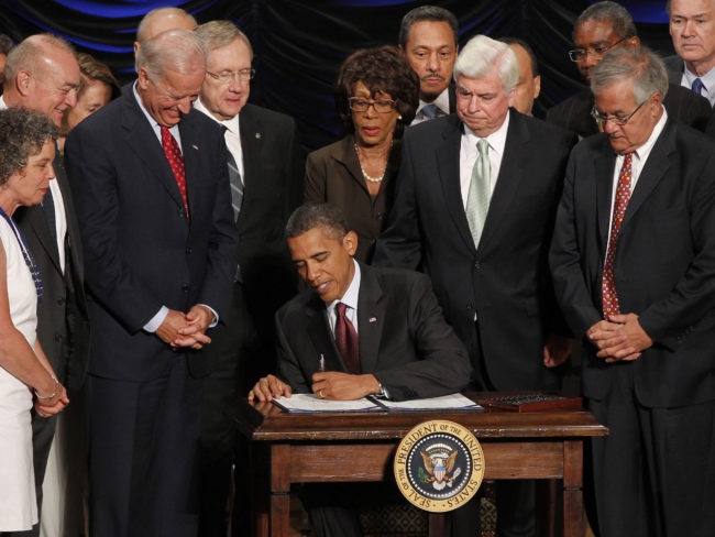 President Obama signs the Dodd-Frank financial overhaul bill in Washington on July 21, 2010. Five years later, debate over the effectiveness of the legislation continues. Charles Dharapak/AP