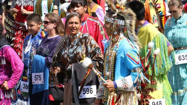 People attend the 45th annual Mille Lacs Band of Ojibwe powwow Saturday, Aug. 20, 2011, at the Iskigamizigan Powwow Grounds in Onamia, Minn. AP