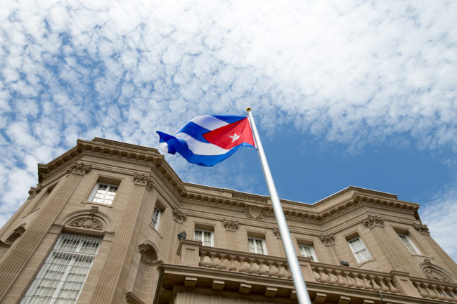 The Cuban flag is raised over their new embassy in Washington, on Monday. Cuba's blue, red and white-starred flag was hoisted Monday at the country's embassy in Washington in a symbolic move signaling the start of a new, post-Cold War era in U.S.-Cuba relations. Andrew Harnik/AP
