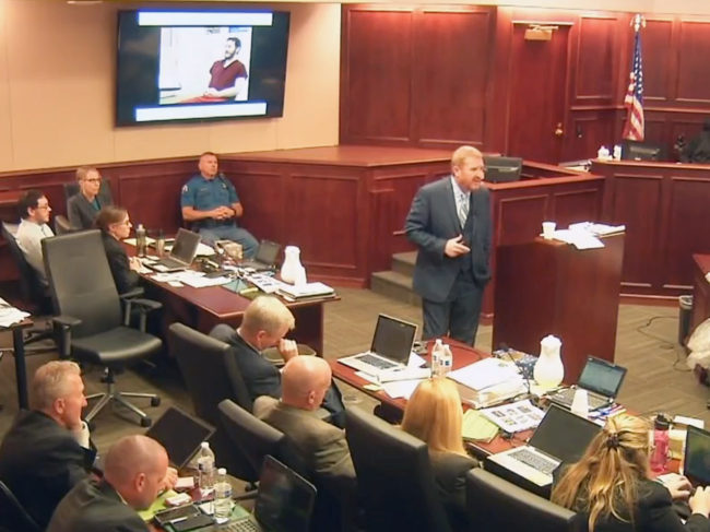 In this image taken from video, James Holmes (upper far left) listens to defense attorney Daniel King give closing arguments during Holmes' trial in Centennial, Colo., on Tuesday. Holmes was found guilty Thursday of first-degree murder in the deaths of 12 people at a Colorado theater. Colorado Judicial Department /AP