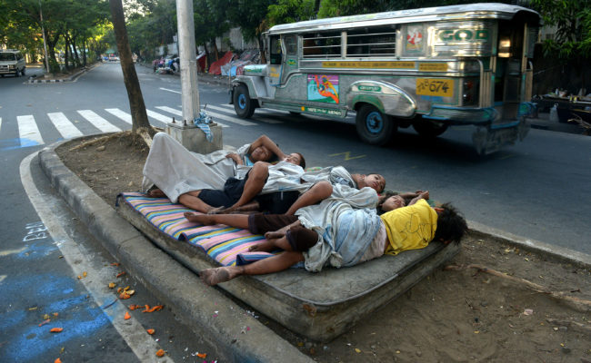 Street children sleep on a discarded mattress on a center island near a road crossing in Manila, Philippines, in April. After 15 years of the Millennium Development Goals, Asia as a region has had the fastest progress, reports the U.N., yet hundreds of millions of people there remain in extreme poverty. Jay Directo/AFP/Getty Images