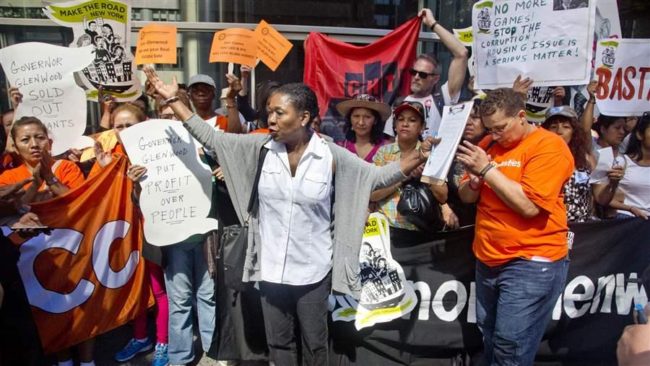 Delsenia Glover, center, protests outside the office of Democratic Gov. Andrew Cuomo against a deal struck this year to extend rent control in New York for four years. (AP)