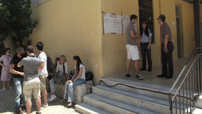 Greeks stand outside of a local school in Athens that served as a voting station. Chris Arnold/NPR