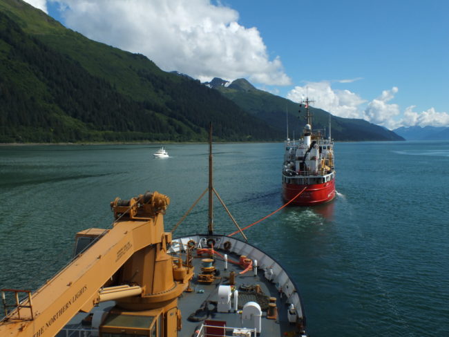 Canadian Coast Guard vessel Bartlett takes a powered-down USCGC Maple in tow during a recent transit of Gastineau Channel. (Photo by Matt Miller/KTOO)