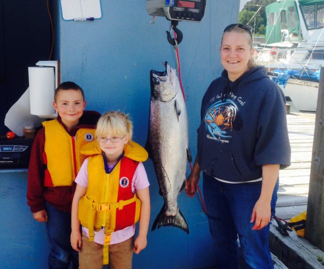 Jody Hass, son Carvin and daughter Landia pose next to the 2015 derby winning fish at the weigh-in station at Douglas Harbor. (Photo by Jason Hass)