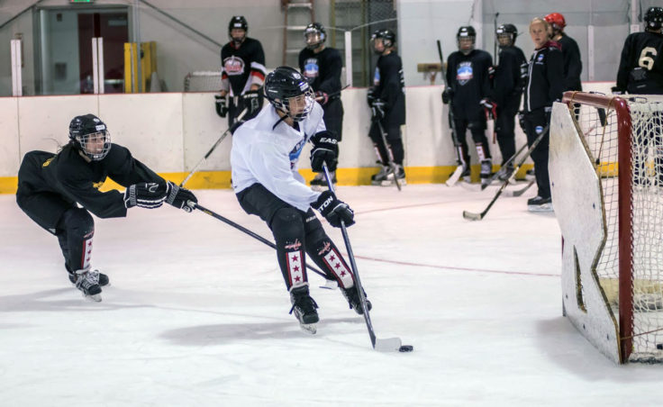 Jaime Hort tries to prevent Cam Smith from reaching the net and getting off a shot during a drill at the Rocky Mountain Hockey School. (Photo by Steve Quinn)