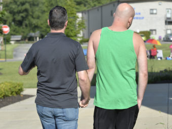 James Yates (left) and William Smith Jr. walk to the Rowan County Courthouse in Morehead, Ky., on Aug. 13 hoping to get a marriage license. They were turned away for a third time Thursday morning. Timothy D. Easley/AP