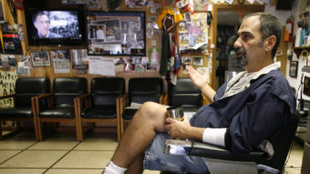 Thomas Checkler, owner of The Old Village Barber in Worthington, Ohio, discusses the impact that the barrage of political ads have on him and his customers during the 2012 presidential election campaign. Mike Munden/AP
