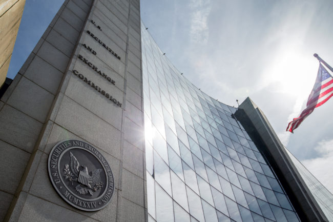 The Securities and Exchange Commission voted 3-2 Wednesday to adopt a rule that would require many public companies to list their chief executives' total annual compensation as a ratio to their workers' median pay. Andrew Harnik/AP