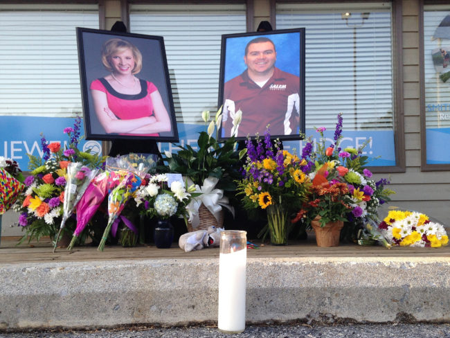 A candle burns in front of a memorial for two slain journalists, Alison Parker and Adam Ward. Jonathan Drew/AP