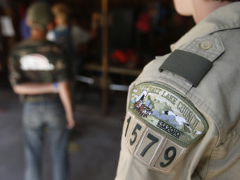 A Boy Scout stands in line to get a canoe at a summer camp outside Payson, Utah. More than 99 percent of Boy Scout troops in Utah are sponsored by the Mormon Church. George Frey/Getty Images
