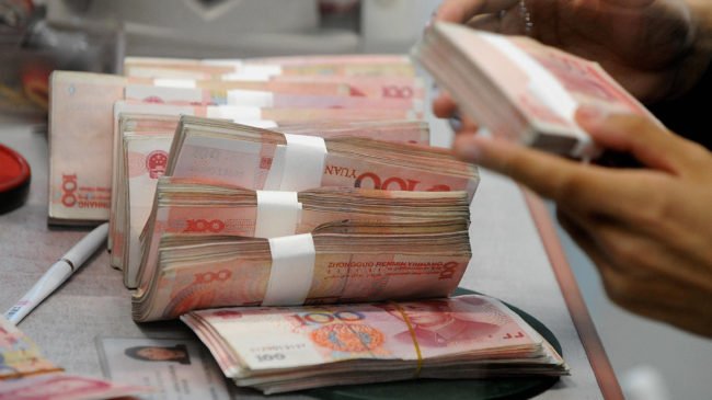 You may not pay in Chinese yuan notes but a drop in their value affects your spending power. Mark Ralston/AFP/Getty Images