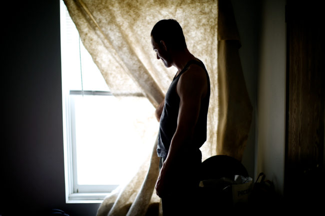Daniel Harmon, a veteran of the wars in both Afghanistan and Iraq, looks out the window of his room at the Hollywood Veterans Center in Los Angeles. The facility provides housing to homeless vets. David Gilkey/NPR