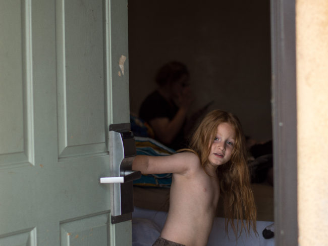 Ian opens the door to the motel room he shares with his mother, Karen. Their living situation has exposed the 5-year-old to conditions most students his age don't have to confront. "He saw way too much in the last few weeks," Karen says. Tess Vigeland/NPR