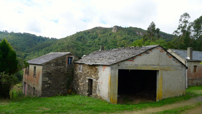 The abandoned village of O Penso, in northwest Spain, is for sale for about $230,000. The last resident died a decade ago. The village includes 100 acres with half a dozen houses, two sprawling farms with room for 70 cattle and a stand-alone bread-making kitchen. Lauren Frayer for NPR