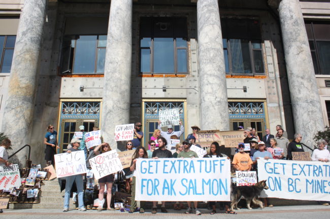 About 40 people stand on the steps of the Alaska Capitol in hopes of encouraging Gov. Bill Walker to "Get Extra Tuff on B.C. Mines." (Photo by Lisa Phu/KTOO)