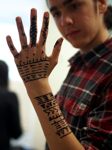 Jacobsen’s son Benjamin came with her from Greenland, and shows off self-administered henna designs made of different traditional patterns, but reconfigured. (Photo by Zachariah Hughes/ KSKA)