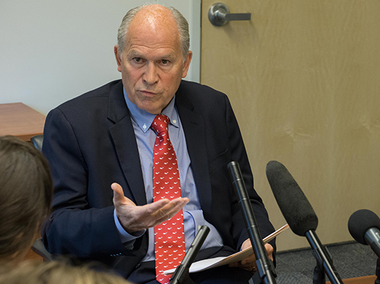 Gov. Bill Walker discusses a tax credit veto with the press, July 1, 2015. (Photo by Jeremy Hsieh/KTOO)