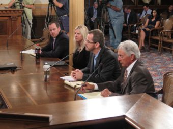 State Rep. Todd Courser (second from right), R-Lapeer, testifies before a House committee Wednesday in Lansing, Mich. Courser resigned amid a vote to expel him for an elaborate scheme to cover up an extramarital affair with a fellow lawmaker. David Eggert/AP