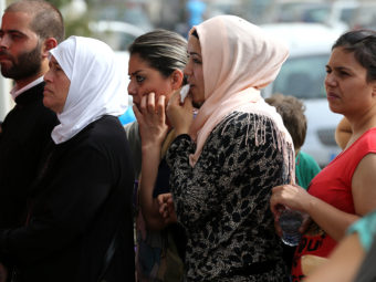 Syrian citizens line up to apply for visas outside the German embassy in Beirut. Lebanon hosts more than 1 million Syrian refugees. Hussein Malla/AP