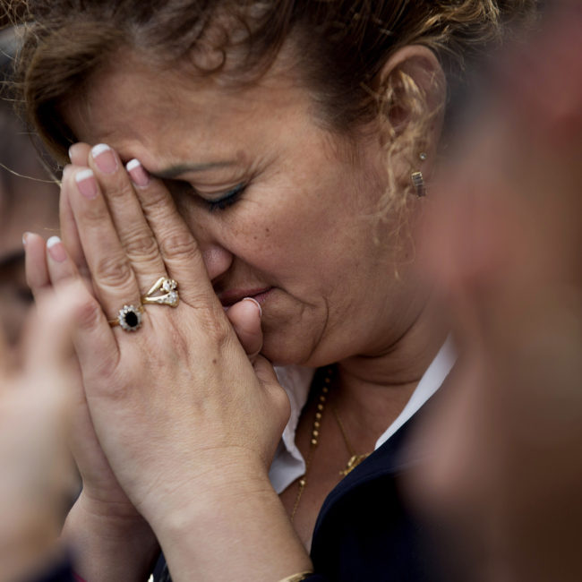 Pilar Cedeno, of Hackensack, N.J., prays as Mass is celebrated by Pope Francis is broadcast to crowds on the Benjamin Franklin Parkway from inside the Cathedral Basilica of Saints Peter and Paul, on Saturday in Philadelphia. (Photo by David Goldman/AP)