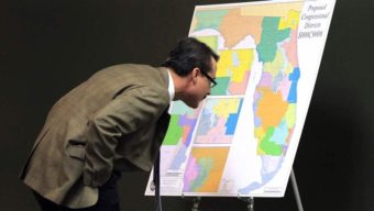 Florida state Sen. Rene Garcia, a Republican, examines a proposed map for the state’s congressional districts that later would be thrown out by the state’s Supreme Court. As legal challenges pile up, some states are considering turning redistricting over to commissions. AP
