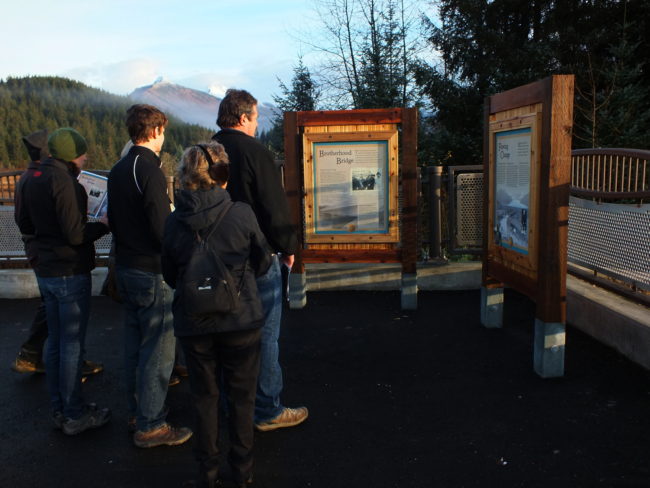 New intepretive panels explaining the history of the Brotherhood Bridge have been erected in the trailhead parking lot adjacent to the bridge. (Photo by Matt Miller/KTOO)