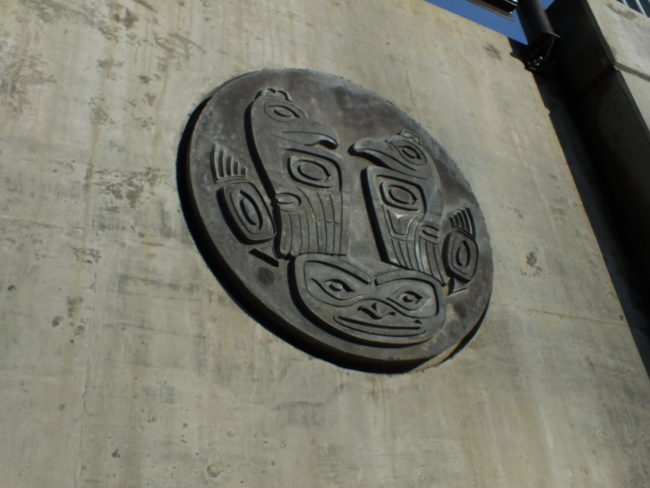 Large concrete versions of the bronze medallions have been erected on the sides of the bridge abutments. (Photo by Matt Miller/KTOO)